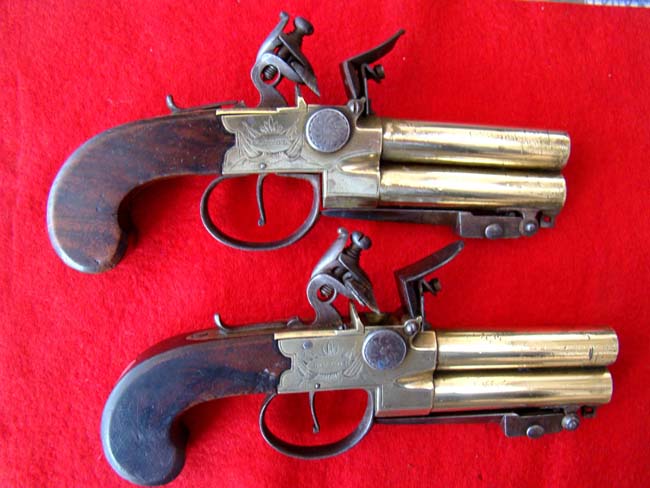 A fine pair of British flintlock pistols with brass over and under barrels with folding bayonets by L.Samuel of Liverpool circa 1780-1800.